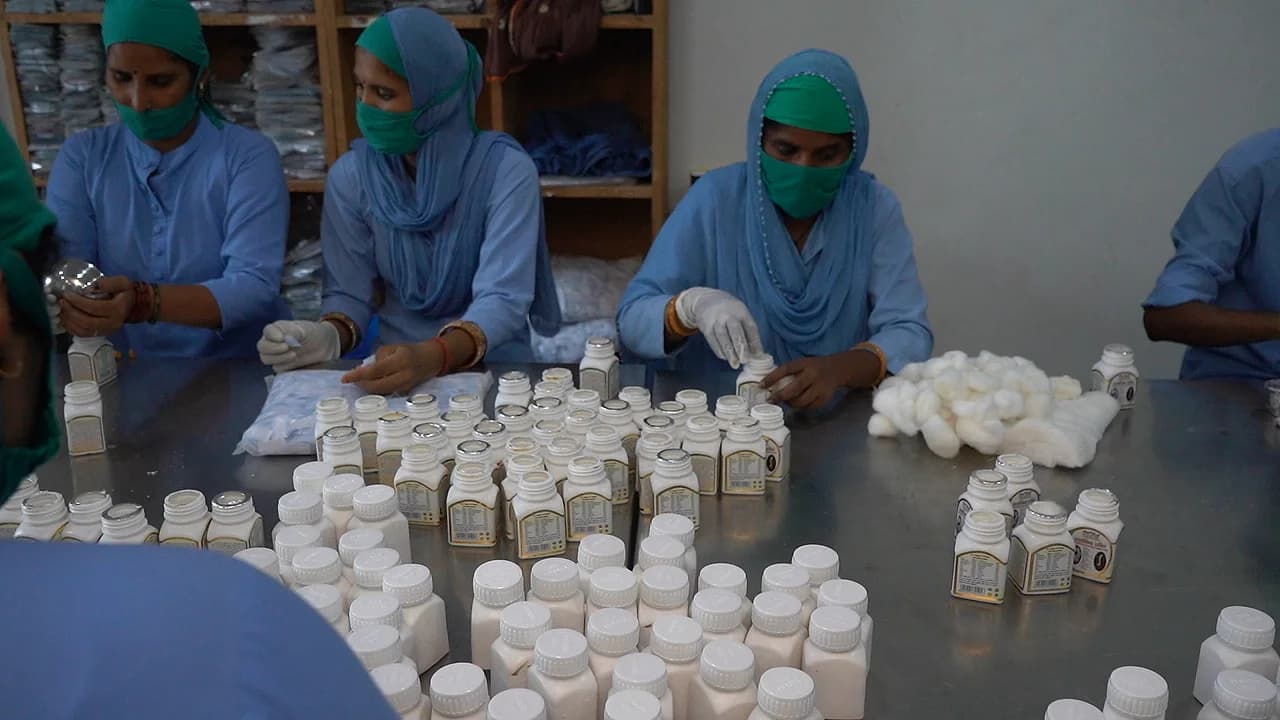 Team sealing and packing finished bottles in the packaging section